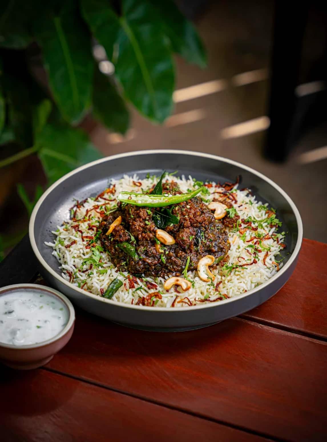 Rice bowl topped with a rich curry, cashews and herbs at Bel Posto The Cafe